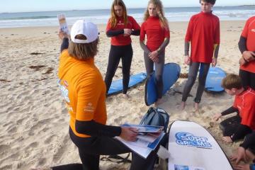 Trainer teaching kids surfing lessons
