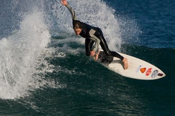 Guy surfing on the beach