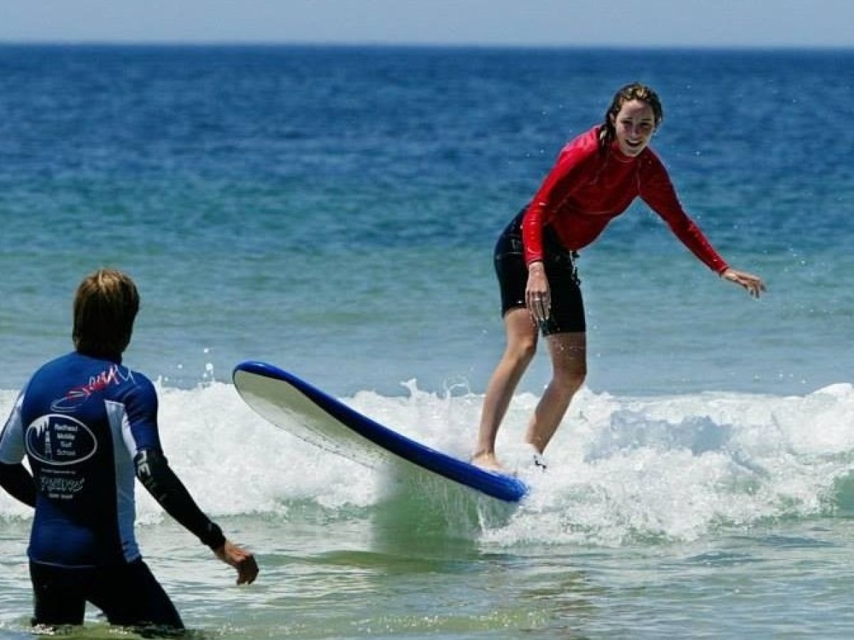 a girl riding a wave on a surfboard in the ocean