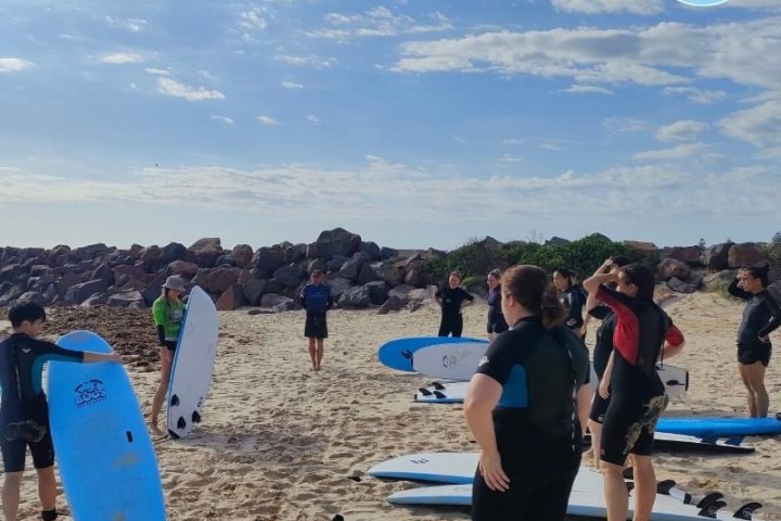 a group of people standing on a beach